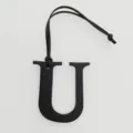 Black leather letter U charm detail, elegant handbag pendant initial accessory close-up - Black