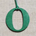 Green leather letter O bag charm pendant detail, elegant handbag accessory for women. - Green