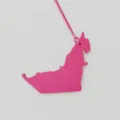 Detailed close-up of the pink leather UAE map bag charm, showing fine grain texture and strap. - Rose Red
