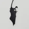Leather map bag charm detail, black leather texture and unique geographic shape pendant. - Black
