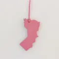 Pink leather Oman map shape bag charm detailed view showing fine texture and leather strap. - Pink