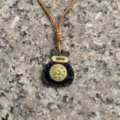 Closeup detail of the handmade genuine leather fortune bag pendant with classic design. - Black