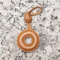 Light brown leather ring bag charm, delicate handcrafted stitch detail, elegant accessory loop. - Letter O / Tan