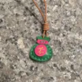 Handcrafted genuine leather lucky bag pendant detail showcasing colorful stitching and cord. - Green