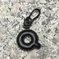 Detailed close-up of a black leather letter Q bag charm pendant showcasing fine texture. - Uppercase Letter Q / Black
