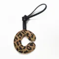 Leopard print leather alphabet letter C bag charm keychain luxury accessory detail shot - Letter C