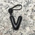 Black leather letter V bag charm and initial keychain for women, stylish car accessory detail view. - Capital Letter V / Black