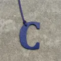 Blue leather letter C bag charm detail close-up view, stylish alphabet accessory for purse. - Sapphire Blue
