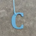 Blue leather letter C bag charm pendant accessory for women handbags and purses detail view. - Sky Blue
