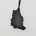 Detailed close-up shot of the black leather map pendant showing delicate texture and craftsmanship. - Black
