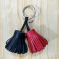 Double color leather tassel bag charm keychain, stylish keyring pendant for handbags and car keys. - Black and Bright Red