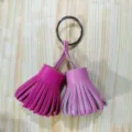 Leather tassel keychain detail, dual color bag charm, metal ring accessory close-up - Pink and Rose Red