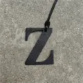 Black leather letter Z bag charm detail, stylish uppercase alphabet pendant for purses. - Black