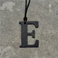 Black leather letter E bag charm detail, luxury style pendant with strap for handbags. - Black