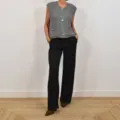 Detailed view of grey chunky knit sleeveless cardigan vest with buttons and pockets. - Gray