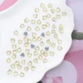 Close-up detail of sparkling heart crystal flatback rhinestones for stunning nail art and crafts. - 6x6mm 100 Pieces/Pack / Light Yellow