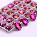 Close-up detail of round crystal sewing rhinestones with vibrant pink flame finish for DIY crafts. - 12mm 40 Pieces/Pack / 54 Rose Red Flame