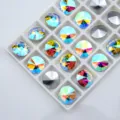 Close-up detail of sparkling round pointed-bottom glass crystal rhinestones with rainbow AB coating. - 6mm 84pcs/pack / AB Color