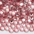 Detailed close-up view of shimmering light pink flatback glass rhinestones for DIY nail art crafts. - 22 Light Pink