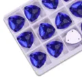 Detail shot of deep blue fat triangle sew-on rhinestones arranged in a neat grid tray. - 07 Dark Blue (Royal Blue)
