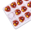 Detailed close-up of orange fat triangle glass sew-on rhinestones, perfect for DIY apparel craft. - Orange Red