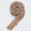 Close-up detail of sparkling resin rhinestone adhesive ribbon roll for DIY crafts and decor. - 14 Peach
