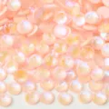 Close-up detail of pink AB flatback crystal rhinestones, sparkling for DIY nail art and crafts. - 194 Luminous Peach Pink AB
