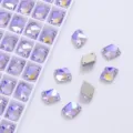 Close-up view of purple AB crystal sew-on rhinestones with dual holes for garment DIY crafts. - Crystal Purple AB