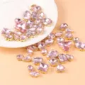 Detailed close-up of pink crystal glass rhinestones with gold claw settings for DIY crafts. - Large Hand-Sewn Rhinestone / 50 Pieces Pack (Approx. 53g) / Pink