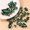 Green crystal glass rhinestones with gold claw settings, perfect for DIY crafts and sewing. - Peacock Green