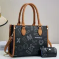 Detailed view of large capacity black tote bag with brown handles and matching card pouch. - Black With Earthy Yellow
