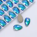 Close-up shot of teardrop AB glass sew-on rhinestones in grid box, sparkling DIY parts - 11x18mm 10pcs/pack / Peacock Green AB