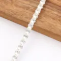 Detail view of DIY rhinestone and pearl trim strip for clothing and crafts accessories. - Pearl & Rhinestone Trim on White Base - 0.8cm Wide