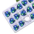 Detailed view of fat triangle sew-on rhinestones in a white tray, AB glass crystals for DIY. - 12mm 28 Pieces/Pack / 31 Grass Green AB