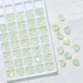 Close-up detail of iridescent heart-shaped crystal rhinestones for nail art and DIY phone cases. - 10mm, 45 Pcs/Pack / 04 Lemon Yellow Mocha Opal