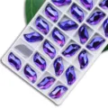 S-Form Kristall Strasssteine zum Aufnähen, lila AB flache Fantasiesteine für DIY Kleidung Zubehör. - 14*30mm 12 Stk./Packung / 26 Violett AB