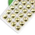 Shiny gold round sew-on glass rhinestones with dual holes for garment decoration. - 14mm 28 Pieces/Pack / Mineral Gold