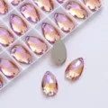 Teardrop AB color sewing glass rhinestones with dual holes, ideal for DIY apparel and crafts. - Champagne AB