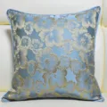 Close-up detail of blue jacquard cushion cover featuring elegant gold floral pattern. - Light Blue 04 Piping