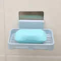 Wall-mounted plastic soap dish with drainage rack and adhesive backing for bathroom use. - Nordic Blue