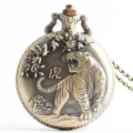Vintage bronze quartz pocket watch with embossed tiger design and retro necklace chain. - Tiger Zodiac
