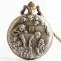 Vintage bronze quartz pocket watch featuring detailed Chinese zodiac monkey relief and chain. - Monkey Zodiac