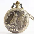 Detailed view of antique bronze pocket watch with dog relief carving and chain necklace. - Dog Zodiac