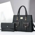 Zwarte PU lederen handtas en bijpassende clutch set met elegante gouden hardware details. - Zwart