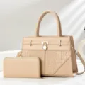 Detailed view of the stylish beige handbag featuring embossed texture and gold padlock. - Khaki