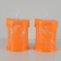 Halloween LED glowing candles with spooky castle and spider web designs for festive decor. - Orange