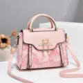 Pink women top handle shoulder handbag with elegant floral embossing and metal swan hardware. - Pink - Undersea World