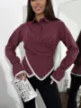 Detail view of the stylish burgundy striped wrap blouse with elegant lace trim cuffs and hem. - S / Tops / Burgundy