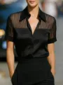 Close-up detail of the black satin short sleeve blouse with sheer vertical stripe pattern. - S / Black