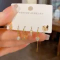 Gold plated butterfly hoop and stud earrings set featuring pearls and sparkling zirconia. - Gradient Butterfly Huggie Set / Orange